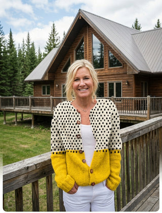 Full-length view of the Junella cardigan styled with white trousers outdoors